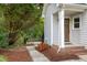 Charming front entrance with brick steps, wooden door and front porch at 175 Fox Run Rd, Youngsville, NC 27596