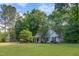 Inviting one-story home with a spacious lawn and mature trees surrounding the property at 175 Fox Run Rd, Youngsville, NC 27596