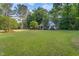 Charming home featuring a well-manicured lawn and mature trees, offering a serene and inviting curb appeal at 175 Fox Run Rd, Youngsville, NC 27596