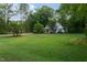 Beautifully maintained front yard with lush green grass and landscaping, leading to a welcoming home exterior at 175 Fox Run Rd, Youngsville, NC 27596