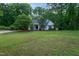 Home with a spacious front yard, mature trees and inviting entryway, set in a serene, green neighborhood at 175 Fox Run Rd, Youngsville, NC 27596