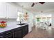 Well-lit kitchen with black and white cabinets, open shelving and adjacent dining area at 175 Fox Run Rd, Youngsville, NC 27596