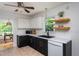 Bright kitchen with black and white cabinets, modern appliances, and tile flooring at 175 Fox Run Rd, Youngsville, NC 27596