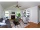 Bright living room with fireplace, vaulted ceiling, and custom built-in shelving at 175 Fox Run Rd, Youngsville, NC 27596