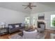 Cozy living room featuring hardwood floors, fireplace, and neutral decor at 175 Fox Run Rd, Youngsville, NC 27596