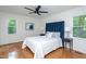 Spacious main bedroom features a large headboard, hardwood floors, with two windows at 175 Fox Run Rd, Youngsville, NC 27596