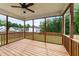 A covered back porch with wooden floors and railings overlooks a fenced backyard at 188 Karlov Rd, Garner, NC 27529
