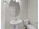 Bathroom with pedestal sink, oval mirror, and toilet at 188 Karlov Rd, Garner, NC 27529