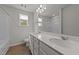 Bright bathroom with double vanity, two windows and tub/shower combo providing a functional space at 188 Karlov Rd, Garner, NC 27529