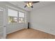 Bedroom featuring wood floor, two large windows with blinds and ceiling fan with lights at 188 Karlov Rd, Garner, NC 27529