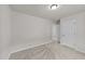 A carpeted bedroom with neutral walls and a white door, offering a blank canvas for personalization at 188 Karlov Rd, Garner, NC 27529