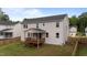 The home's rear exterior displays a covered back porch overlooking a fenced yard and green space at 188 Karlov Rd, Garner, NC 27529
