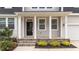 View of the inviting front porch with stone steps, columns and decorative landscaping at 188 Karlov Rd, Garner, NC 27529