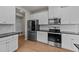 Kitchen features stainless steel appliances, white cabinetry, and granite countertops at 188 Karlov Rd, Garner, NC 27529
