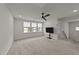 Spacious living room with carpet, three windows, and ceiling fan at 188 Karlov Rd, Garner, NC 27529