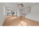 Spacious open-concept living room with wood floors, staircase and view to the kitchen at 188 Karlov Rd, Garner, NC 27529