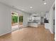 Open living space flows to kitchen and screened deck through sliding glass doors at 188 Karlov Rd, Garner, NC 27529