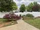 View of the backyard featuring a white fence and walkway at 1924 Barngate Way, Raleigh, NC 27614