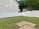 View of the backyard highlighting a white fence, grass, and patio pavers at 1924 Barngate Way, Raleigh, NC 27614