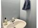 Bathroom featuring a pedestal sink, blue walls, and a towel at 1924 Barngate Way, Raleigh, NC 27614