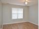 Bright bedroom featuring wood flooring, neutral walls, and a ceiling fan at 1924 Barngate Way, Raleigh, NC 27614
