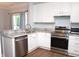 Modern kitchen featuring stainless steel appliances, granite countertops, and bright white cabinets at 1924 Barngate Way, Raleigh, NC 27614