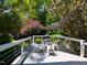 Inviting back deck with outdoor furniture surrounded by lush greenery at 201 Cooke St, Raleigh, NC 27601