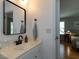 Well-lit bathroom with a white vanity, modern faucet, and view to the main bedroom at 201 Cooke St, Raleigh, NC 27601