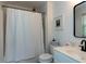 Clean bathroom with a shower-tub combo, white vanity, and modern fixtures at 201 Cooke St, Raleigh, NC 27601