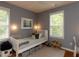 Cozy bedroom with two windows, a twin bed, and playful decor at 201 Cooke St, Raleigh, NC 27601