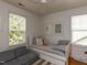 Well-lit bedroom with a daybed, couch, and two large windows at 201 Cooke St, Raleigh, NC 27601