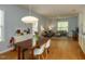 Spacious dining area with hardwood floors and a view into the living room with natural lighting at 201 Cooke St, Raleigh, NC 27601