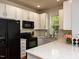 Modern kitchen with white cabinets, stainless steel appliances, and quartz countertops at 201 Cooke St, Raleigh, NC 27601