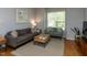 Comfortable living room with hardwood floors, neutral walls, and a cozy seating arrangement at 201 Cooke St, Raleigh, NC 27601