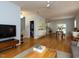 Open-concept living area with hardwood floors connecting the living, dining, and kitchen spaces at 201 Cooke St, Raleigh, NC 27601