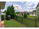 This fenced backyard has a grill, a small patch of lawn, and a great view of the neighborhood at 210 Mayfield Dr, Apex, NC 27539