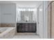 Bathroom features double vanity with dark wood cabinets, and a soaking tub at 210 Mayfield Dr, Apex, NC 27539