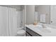 This bathroom features a shower with curtain and a vanity with sink, mirror, and decor at 210 Mayfield Dr, Apex, NC 27539