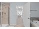 Bathroom showing the tiled shower stall and the tub with view through to main bedroom at 210 Mayfield Dr, Apex, NC 27539