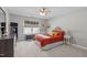 Bedroom features a ceiling fan, large window, and closet at 210 Mayfield Dr, Apex, NC 27539