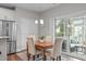 Eat-in kitchen area featuring hardwood floors, bright lighting, stainless steel appliances and sliding door access to the deck at 210 Mayfield Dr, Apex, NC 27539