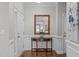 Elegant entryway featuring hardwood floors, a decorative table, and beautiful wall decor at 210 Mayfield Dr, Apex, NC 27539
