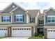Charming townhome featuring stone accents, neutral siding, and a well-manicured lawn at 210 Mayfield Dr, Apex, NC 27539