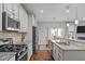 Bright kitchen features stainless steel appliances, granite counters and connects to the dining area and living room at 210 Mayfield Dr, Apex, NC 27539