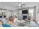 Open living space features hardwood floors, a fireplace, a mounted television, and sliding doors to the patio at 210 Mayfield Dr, Apex, NC 27539