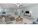 Spacious upstairs living room includes a large sectional couch, ceiling fan, and light blue walls and neutral carpeting at 210 Mayfield Dr, Apex, NC 27539