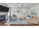 Comfortable living room featuring hardwood floors, a fireplace, and stylish decor at 210 Mayfield Dr, Apex, NC 27539