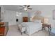 Bright main bedroom with ceiling fan, ensuite bathroom, and chest of drawers at 210 Mayfield Dr, Apex, NC 27539