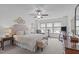 Cozy main bedroom features a ceiling fan, sitting area, and an upholstered headboard at 210 Mayfield Dr, Apex, NC 27539