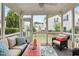This is a screened porch with cushioned outdoor furniture overlooking green space and other houses at 210 Mayfield Dr, Apex, NC 27539